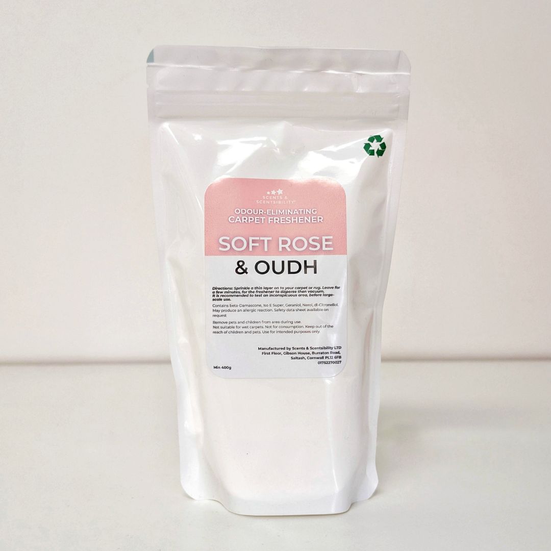 White packaging of a carpet freshener with a pink label on a white background