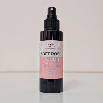 Black spray bottle labeled 'Soft Rose & Oudh' on a light background