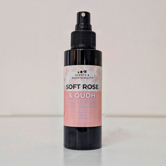 Black spray bottle labeled 'Soft Rose & Oudh' on a light background