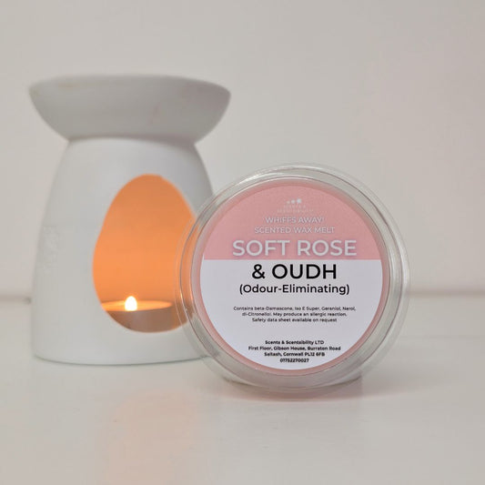 Candle warmer with a lit candle and a container labeled 'Soft Rose & Oudh' on a white background
