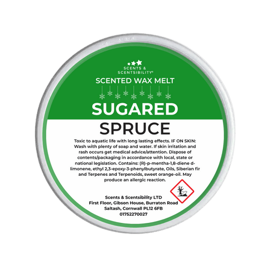 Scented wax melt container labeled 'Sugared Spruce' on a green background