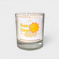 Scented candle labeled 'Sunny Days' with a sun design on a white background
