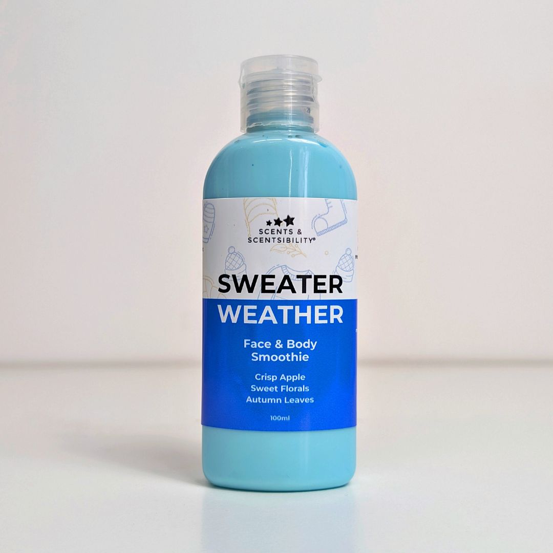 Blue bottle of 'Sweater Weather' face and body smoothie body lotion with a label on a light grey background