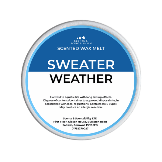 Scented wax melt container labeled 'Sweater Weather' on a green background