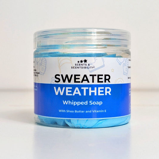 Jar of 'Sweater Weather' whipped soap with a blue label on a white background