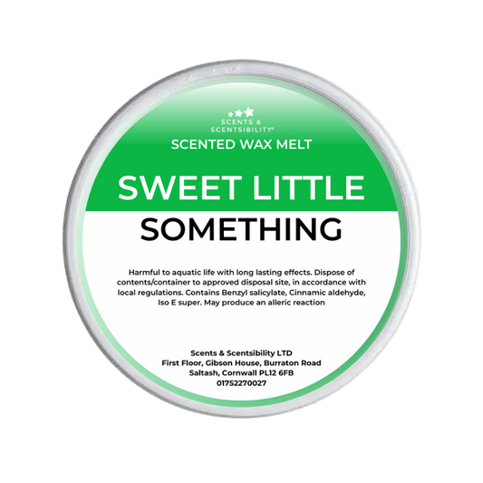 Scented wax melt container labeled 'Sweet Little Something' on a green background