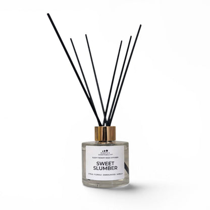 Diffuser with black sticks labeled 'Sweet Slumber' on a white background