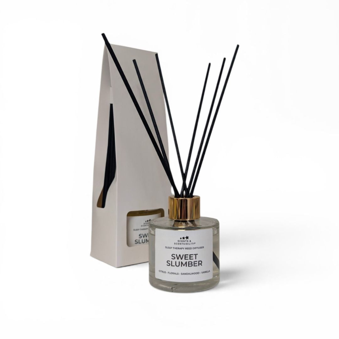 Diffuser bottle labeled 'Sweet Slumber' with black sticks on a white background