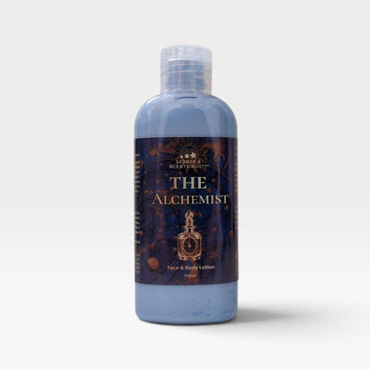A bottle of 'The Alchemist' Face & Body Lotion by Scents & Scentsibility, featuring a light blue translucent liquid and a dark label with gold lettering, set against a plain light gray background.