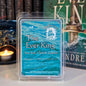 Wax melt packaging labeled 'The Ever King' with a candle and book in the background