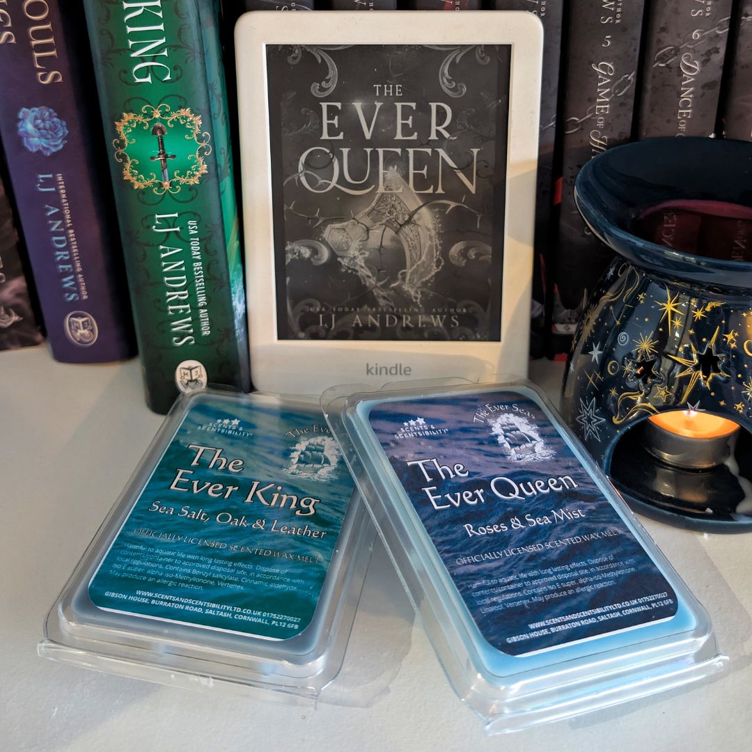 Two 'The Ever Queen' wax melts packaging with a Kindle device displaying the book cover in the background.