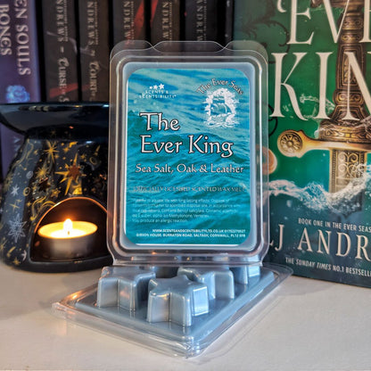 Packaged wax melts with 'The Ever King' scent in front of a book titled 'The Ever King' by E. L. James.