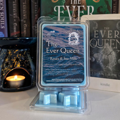 Packaged wax melts labeled 'The Ever Queen' with a wax melt burner and books in the background.
