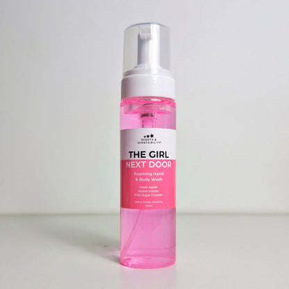 Pink bottle of 'The Girl Next Door' foaming hand & body wash on a white background