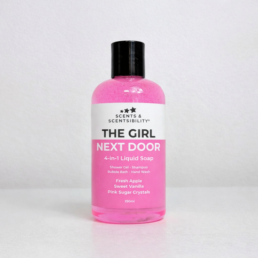 A bottle of pink liquid soap labelled The Girl Next Door on a white background