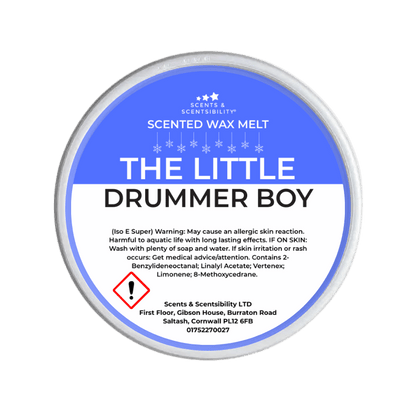 Scented wax melt container labeled 'The Little Drummer Boy' on a green background