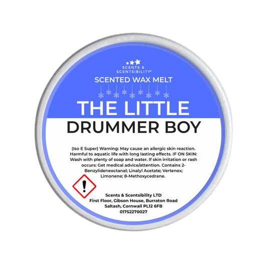 Scented wax melt container labeled 'The Little Drummer Boy' on a green background
