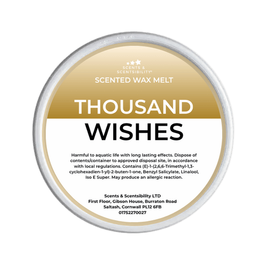 Scented wax melt container labeled 'Thousand Wishes' on a green background