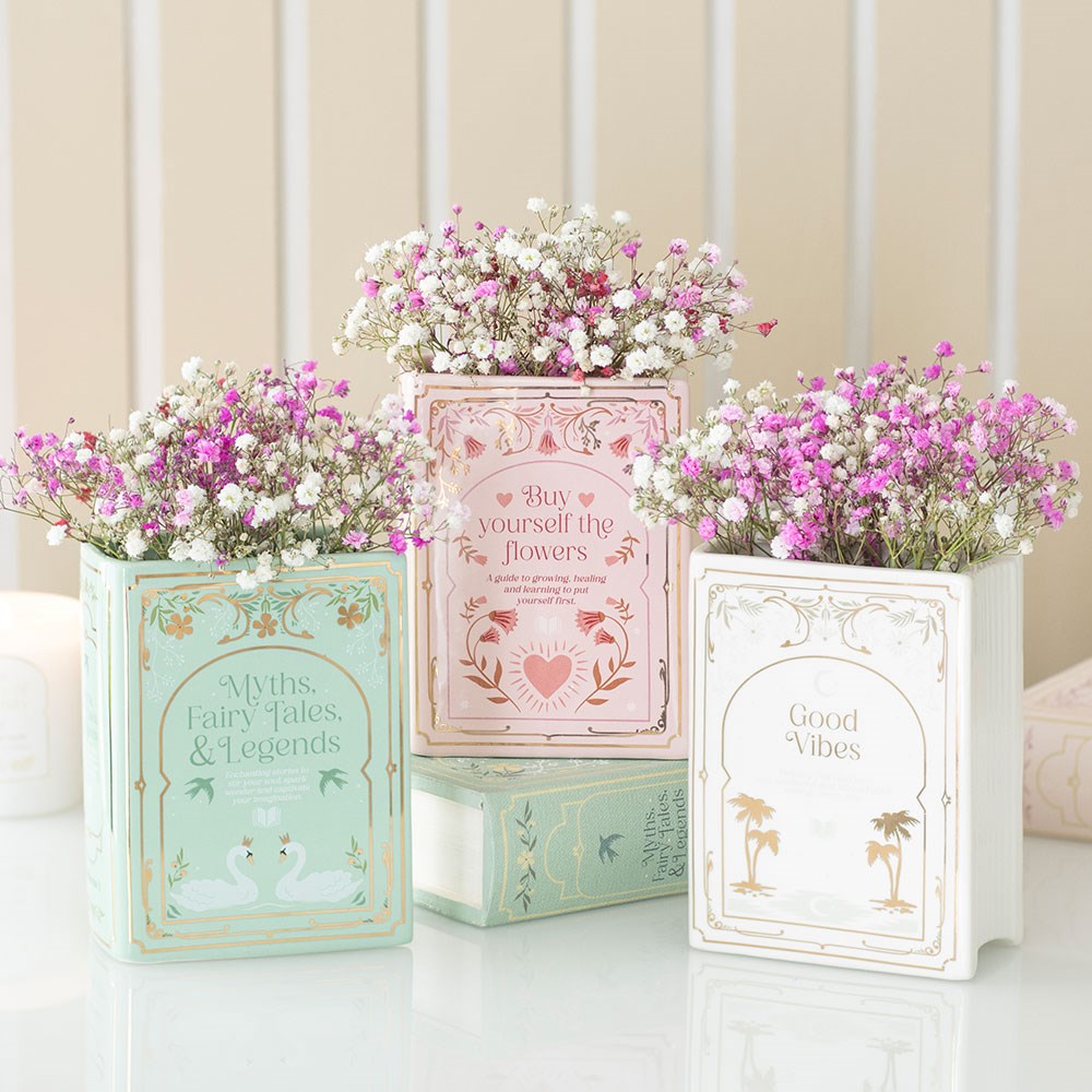 Three book shaped vases with dried flowers