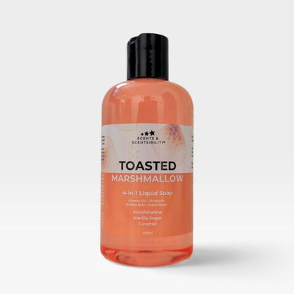 A bottle of Scents & Scentsibility 'Toasted Marshmallow' 4-in-1 liquid soap, featuring a translucent peach-colored liquid inside a clear bottle with a black cap, set against a light gray background.