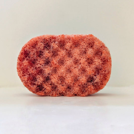 A textured dark orange sponge, filled with soap.