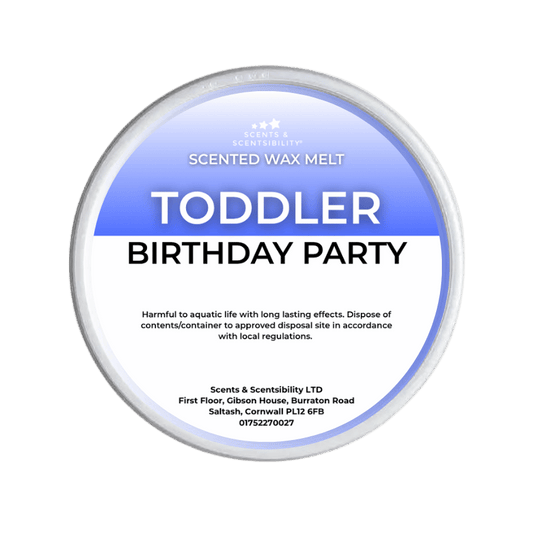 A Scents & Scentsibility 'Toddler Birthday Party' scented wax melt, shown against a solid dark green background.