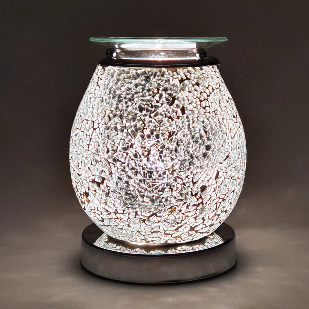 Decorative wax melt warmer with mosaic design on a dark background