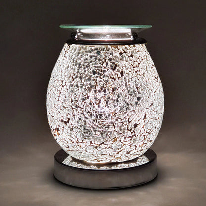 Decorative wax melt warmer with mosaic design on a dark background