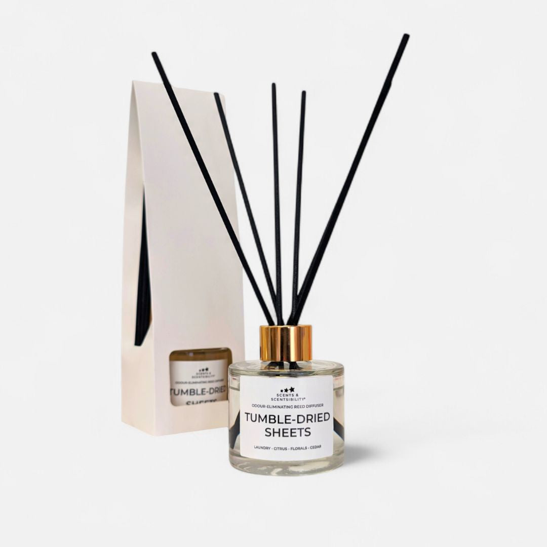 Diffuser with black reeds and a white label on a light gray background