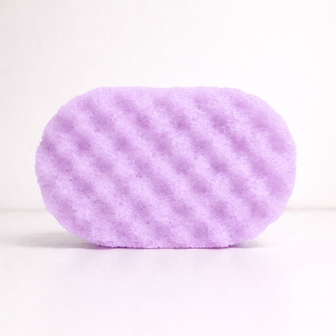 Purple textured sponge on a white background