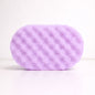 Purple textured sponge on a white background