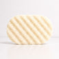 A cream coloured sponge with a textured, porous surface, shown on a clean white background.