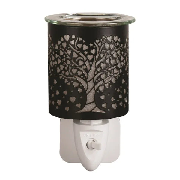 Decorative wax melt plug in melter with tree and heart design on a white background