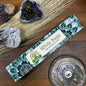 Box of White Sage incense with decorative elements on a wooden surface