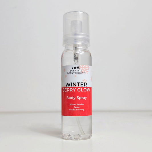 A bottle of body spray with a red and white label that says Winter Berry Glow