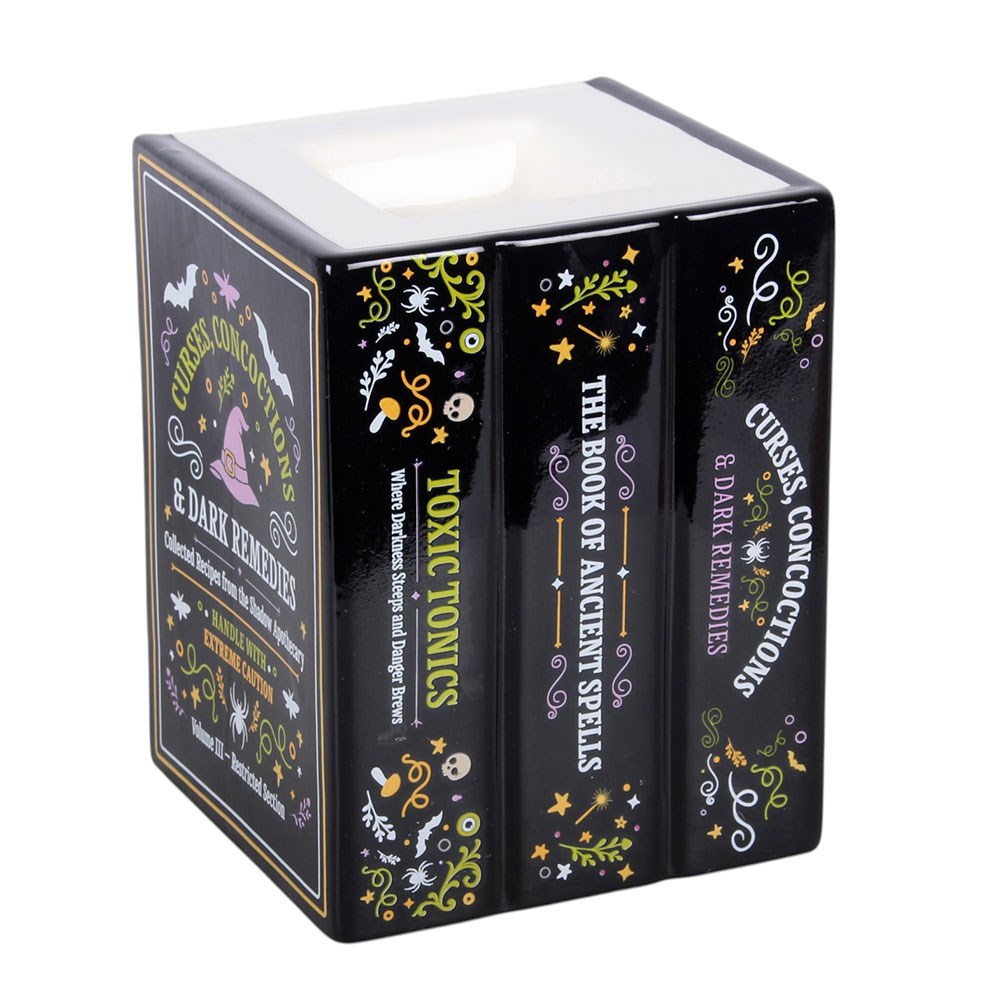 A black, decorative wax melt and oil burner, shaped like a stack of books about ancient spells and curses