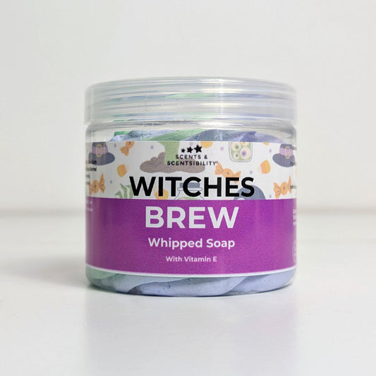 Jar of 'Witches Brew' whipped soap with a colorful label on a white background