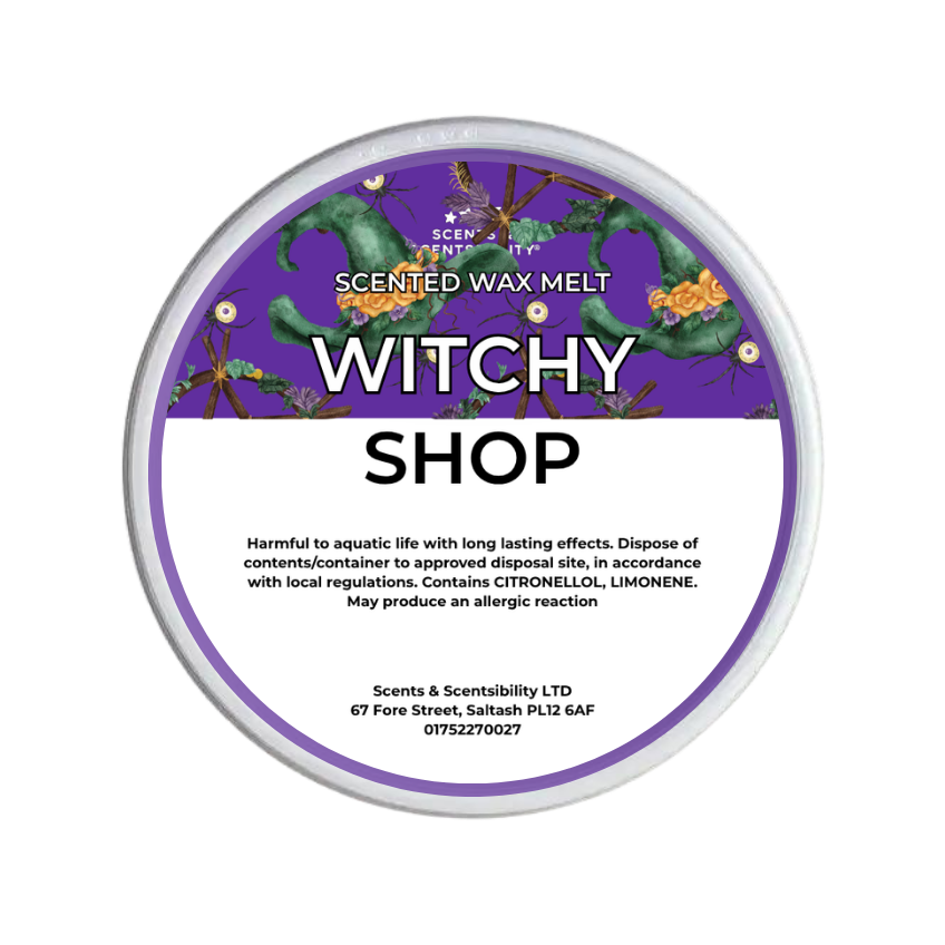 A round tub of Scents & Scentsibility 'Witchy Shop' scented wax melt, featuring a purple label with a green witch, orange flowers, and black spiders, set against a plain white background.
