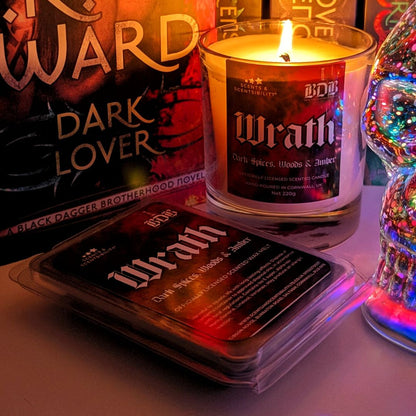 Candle with ' Wrath' packaging on a table with Dark Lover book by J R Ward background