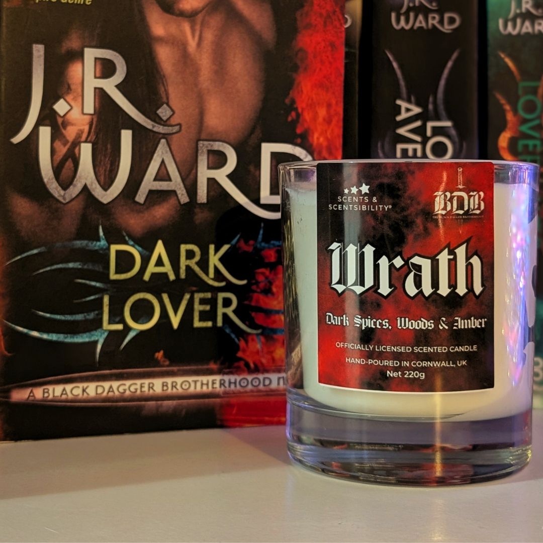 Candle labeled 'Wrath' in front of a book titled 'Dark Lover' by J.R. Ward