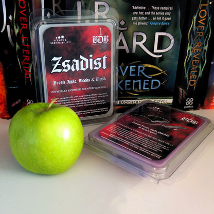 BDB Zsadist scented wax melts with a green apple on a white surface